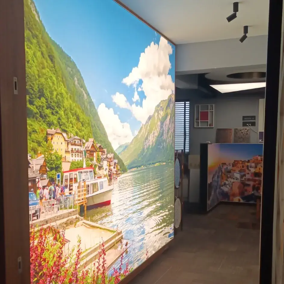 Backlit printed stretch wall showing a lakeside town